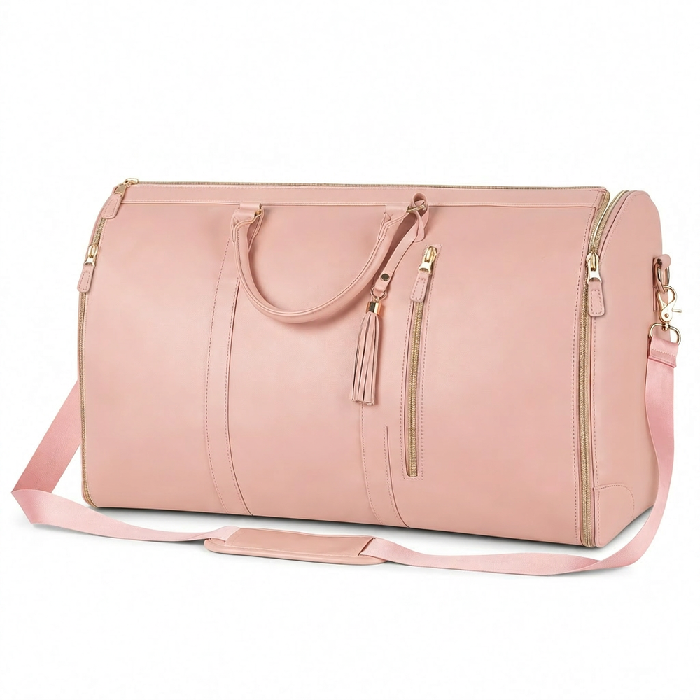 Pink duffel bag with gold zippers, tassel detail, and adjustable shoulder strap for travel or gym use